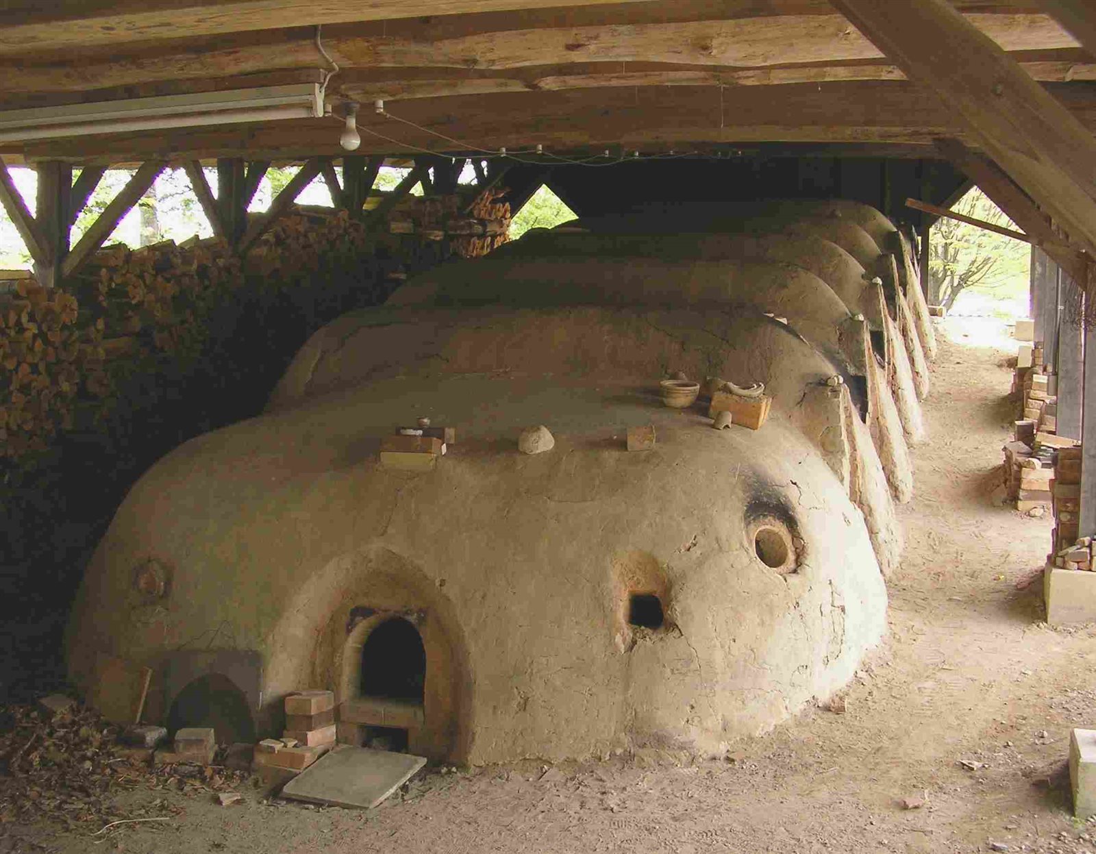 木造の屋根の下に、土でできた丸い焼成室がいくつも連なる益子の登り窯