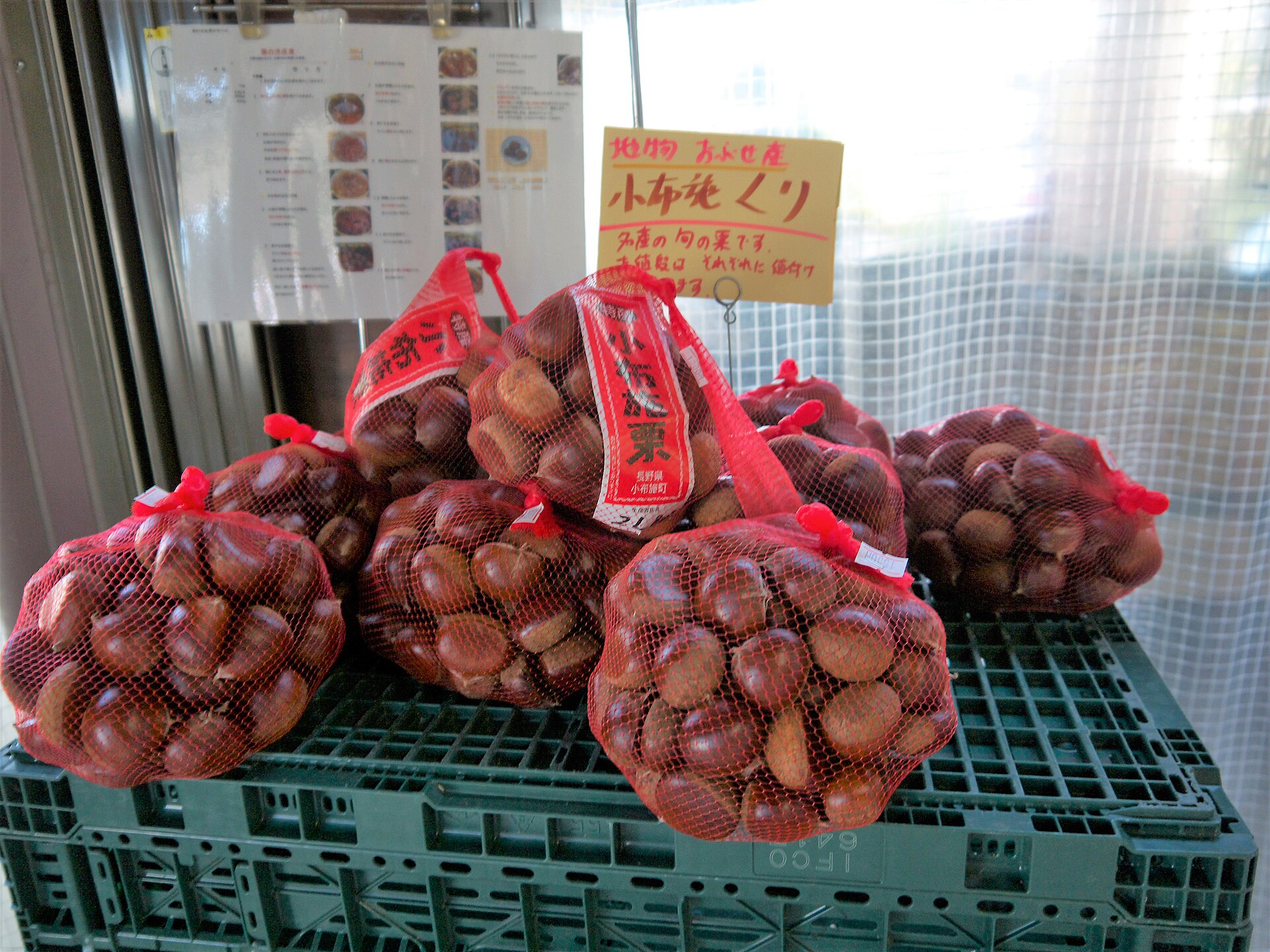 赤いネットに入った小布施産の栗の袋が積まれた売り場