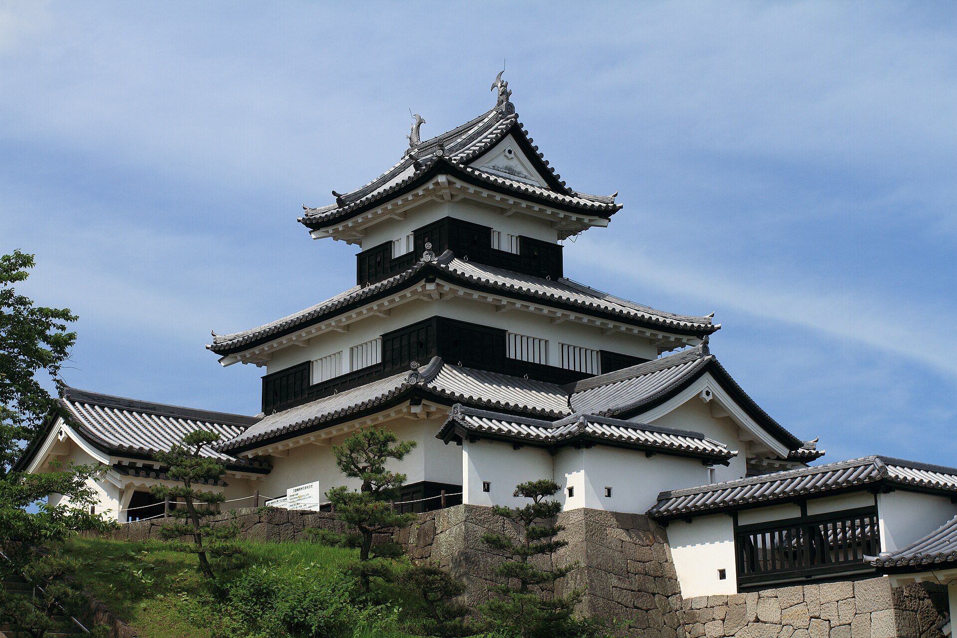 青空を背に、黒い板壁と白漆喰の三層が重なる小峰城の三重櫓